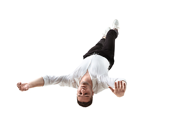 Image showing Mid-air beauty. Full length studio shot of attractive young man hovering in air and keeping eyes closed