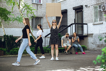 Image showing Dude with sign - woman stands protesting things that annoy her