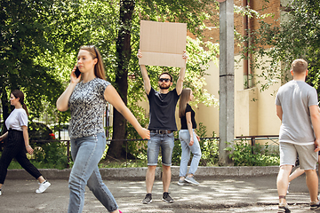 Image showing Dude with sign - man stands protesting things that annoy him