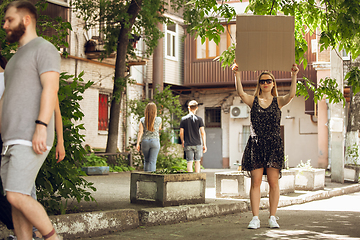 Image showing Dude with sign - woman stands protesting things that annoy her