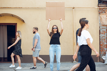 Image showing Dude with sign - woman stands protesting things that annoy her