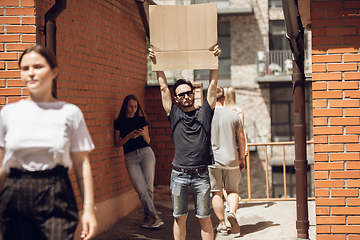 Image showing Dude with sign - man stands protesting things that annoy him