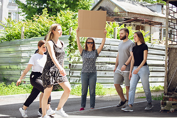 Image showing Dude with sign - woman stands protesting things that annoy her