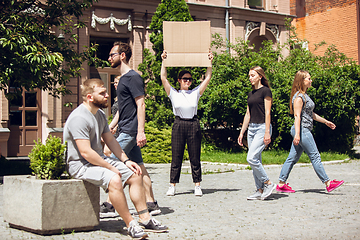 Image showing Dude with sign - woman stands protesting things that annoy her