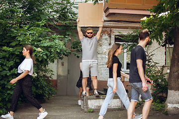 Image showing Dude with sign - man stands protesting things that annoy him