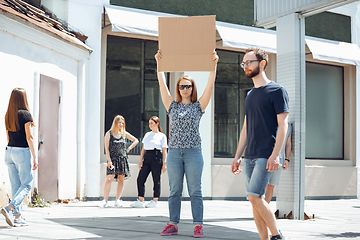 Image showing Dude with sign - woman stands protesting things that annoy her