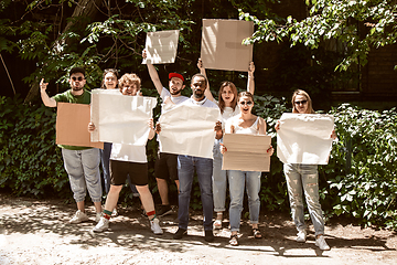 Image showing Diverse group of people protesting with blank signs. Protest against human rights, abuse of freedom, social issues