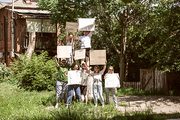 Image showing Diverse group of people protesting with blank signs. Protest against human rights, abuse of freedom, social issues