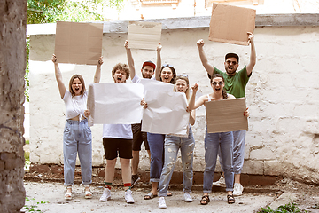 Image showing Diverse group of people protesting with blank signs. Protest against human rights, abuse of freedom, social issues