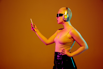 Image showing Portrait of young caucasian woman in fashionable eyewear on brown background with copyspace, unusual and freaky appearance