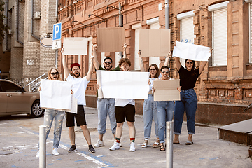 Image showing Diverse group of people protesting with blank signs. Protest against human rights, abuse of freedom, social issues