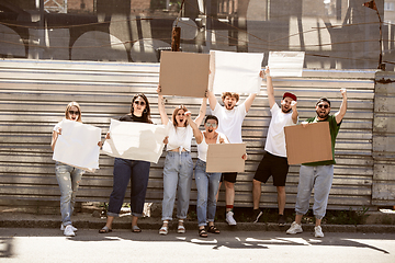 Image showing Diverse group of people protesting with blank signs. Protest against human rights, abuse of freedom, social issues