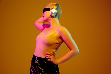 Image showing Portrait of young caucasian woman in fashionable eyewear on brown background with copyspace, unusual and freaky appearance