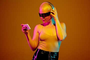 Image showing Portrait of young caucasian woman in fashionable eyewear on brown background with copyspace, unusual and freaky appearance