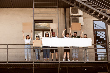 Image showing Diverse group of people protesting with blank signs. Protest against human rights, abuse of freedom, social issues