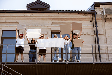 Image showing Diverse group of people protesting with blank signs. Protest against human rights, abuse of freedom, social issues