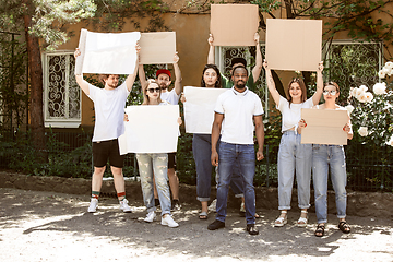 Image showing Diverse group of people protesting with blank signs. Protest against human rights, abuse of freedom, social issues