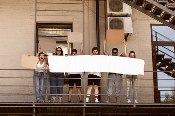 Image showing Diverse group of people protesting with blank signs. Protest against human rights, abuse of freedom, social issues