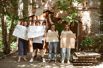 Image showing Diverse group of people protesting with blank signs. Protest against human rights, abuse of freedom, social issues