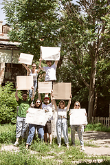 Image showing Diverse group of people protesting with blank signs. Protest against human rights, abuse of freedom, social issues