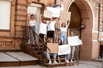 Image showing Diverse group of people protesting with blank signs. Protest against human rights, abuse of freedom, social issues