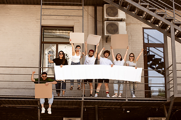 Image showing Diverse group of people protesting with blank signs. Protest against human rights, abuse of freedom, social issues