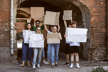 Image showing Diverse group of people protesting with blank signs. Protest against human rights, abuse of freedom, social issues