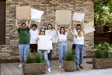 Image showing Diverse group of people protesting with blank signs. Protest against human rights, abuse of freedom, social issues