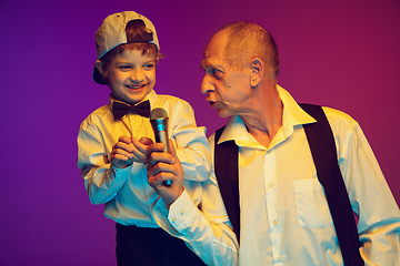 Image showing Senior man having fun and spending time together with boy, grandson. Joyful elderly lifestyle concept