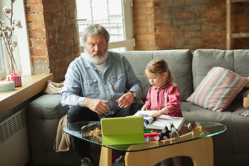 Image showing Grandfather and child playing together at home. Happiness, family, relathionship, education concept.