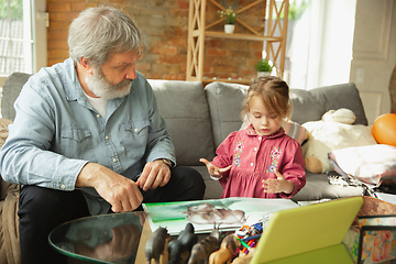 Image showing Grandfather and child playing together at home. Happiness, family, relathionship, education concept.