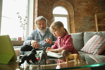 Image showing Grandfather and child playing together at home. Happiness, family, relathionship, education concept.