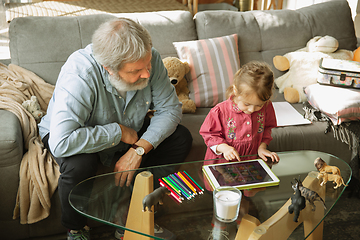 Image showing Grandfather and child playing together at home. Happiness, family, relathionship, education concept.