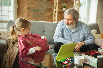 Image showing Grandfather and child playing together at home. Happiness, family, relathionship, education concept.