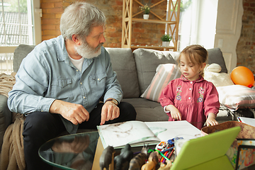 Image showing Grandfather and child playing together at home. Happiness, family, relathionship, education concept.