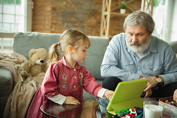 Image showing Grandfather and child playing together at home. Happiness, family, relathionship, education concept.