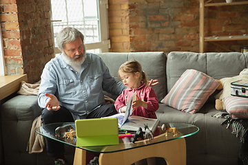 Image showing Grandfather and child playing together at home. Happiness, family, relathionship, education concept.