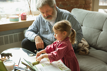 Image showing Grandfather and child playing together at home. Happiness, family, relathionship, education concept.