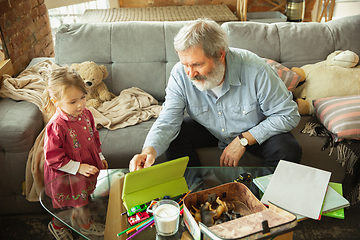 Image showing Grandfather and child playing together at home. Happiness, family, relathionship, education concept.