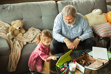 Image showing Grandfather and child playing together at home. Happiness, family, relathionship, education concept.