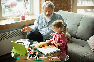 Image showing Grandfather and child playing together at home. Happiness, family, relathionship, education concept.