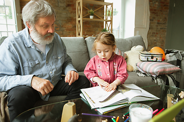 Image showing Grandfather and child playing together at home. Happiness, family, relathionship, education concept.