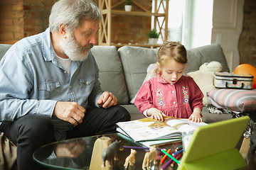 Image showing Grandfather and child playing together at home. Happiness, family, relathionship, education concept.