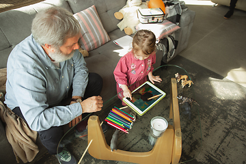 Image showing Grandfather and child playing together at home. Happiness, family, relathionship, education concept.