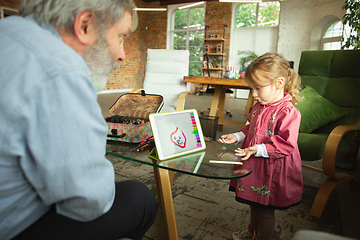 Image showing Grandfather and child playing together at home. Happiness, family, relathionship, education concept.