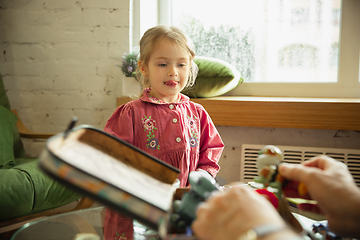 Image showing Grandfather and child playing together at home. Happiness, family, relathionship, education concept.