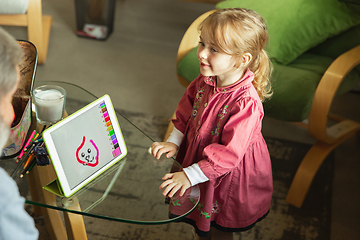 Image showing Grandfather and child playing together at home. Happiness, family, relathionship, education concept.