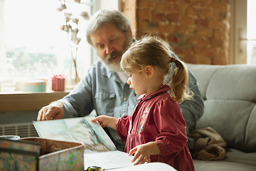 Image showing Grandfather and child playing together at home. Happiness, family, relathionship, education concept.