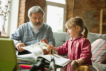 Image showing Grandfather and child playing together at home. Happiness, family, relathionship, education concept.