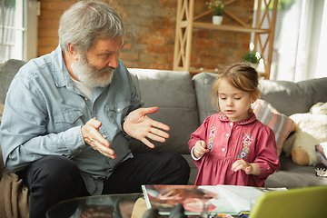 Image showing Grandfather and child playing together at home. Happiness, family, relathionship, education concept.